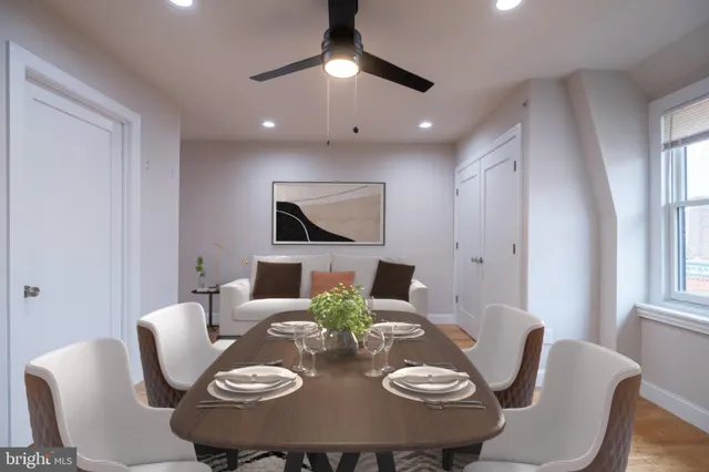 a view of a dining room with furniture a chandelier and wooden floor
