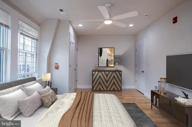 a bedroom with a bed and a flat screen tv