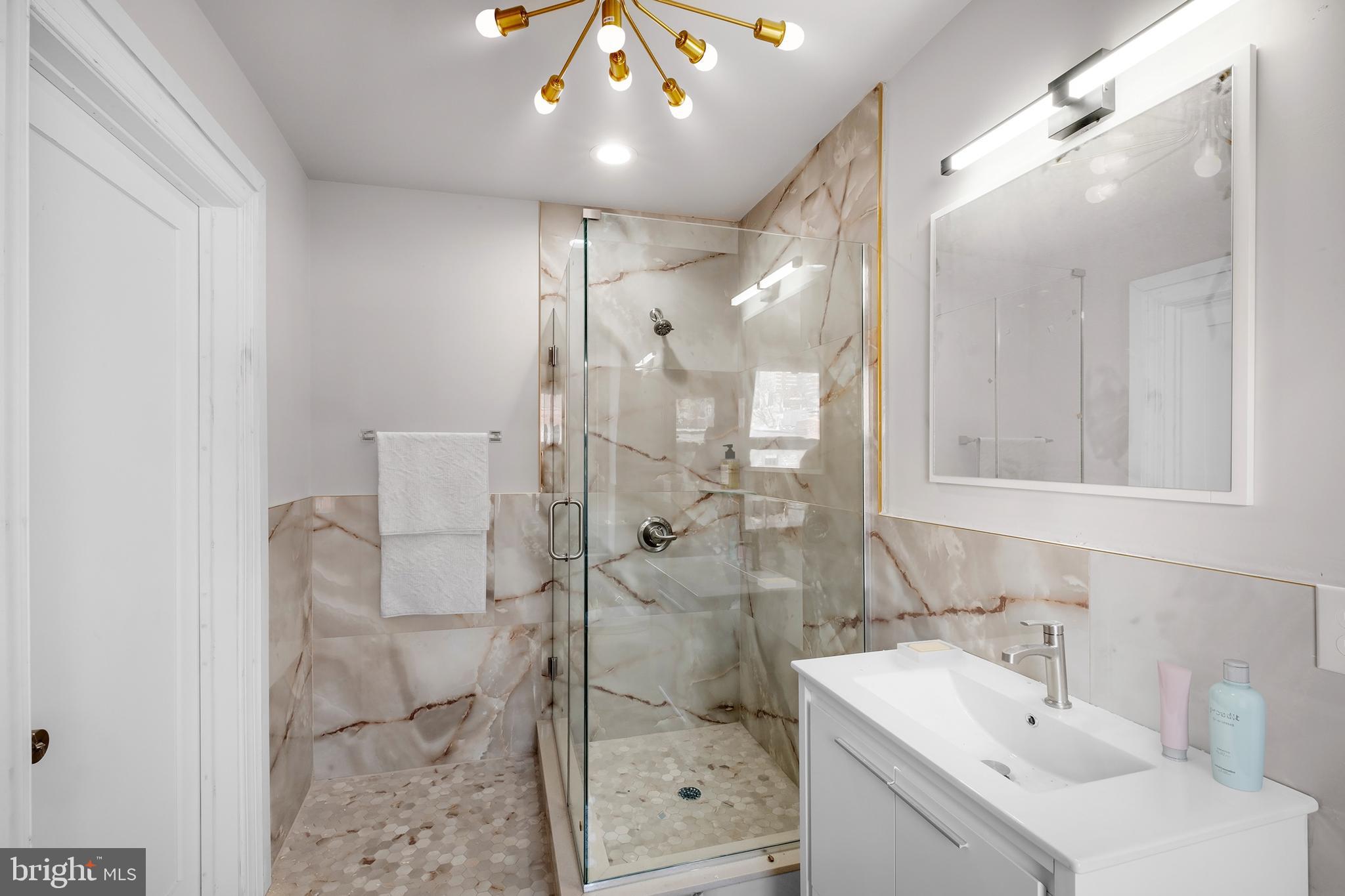 333 South 21st Street, Unit 4 Philadelphia, PA 19103 - Photo 6 of 15 a bathroom with a sink mirror and shower