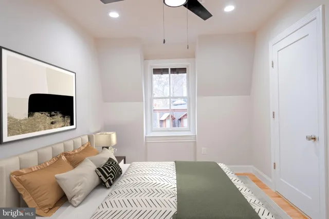 a bedroom with a bed and a window