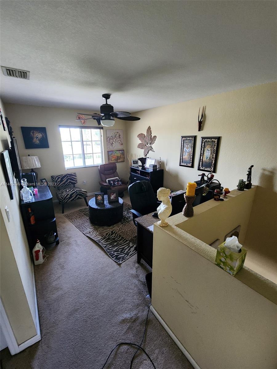 13986 Southwest 276th Street Homestead, FL 33032 - Photo 11 of 28 a living room with furniture and a window
