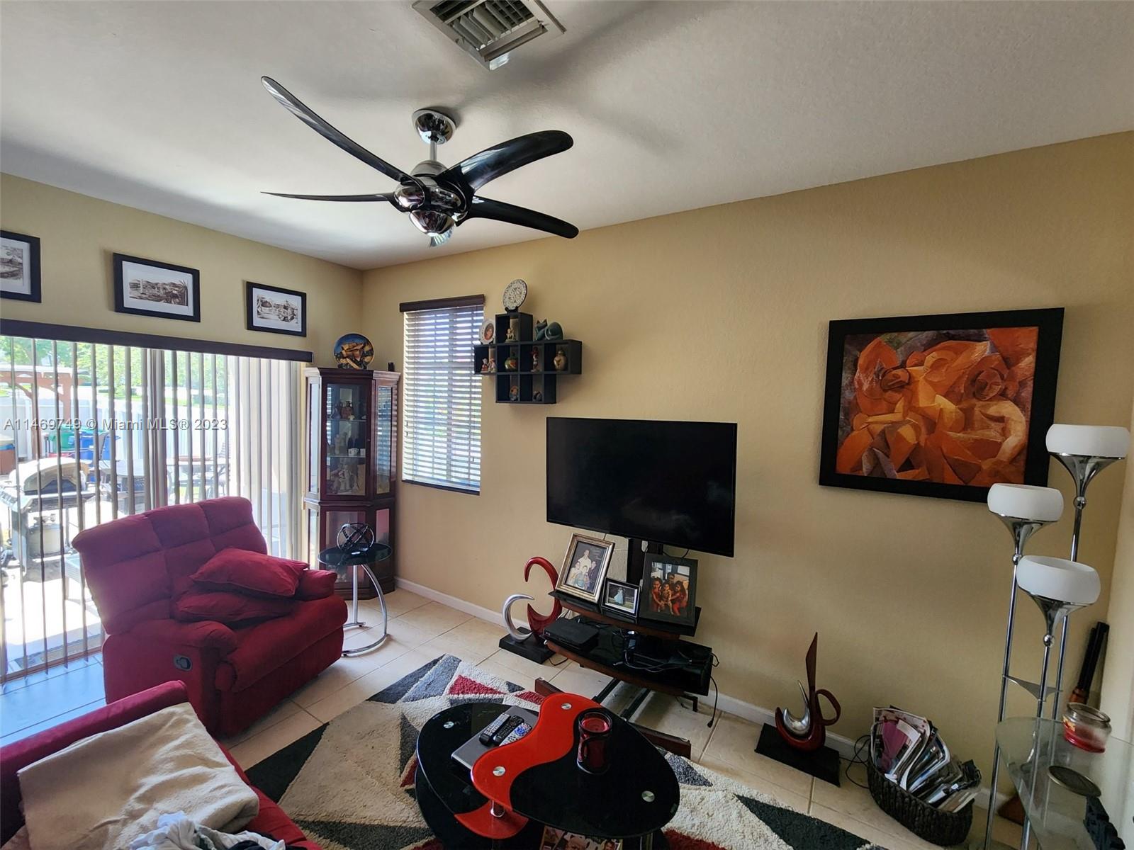 13986 Southwest 276th Street Homestead, FL 33032 - Photo 12 of 28 a living room with furniture and a flat screen tv