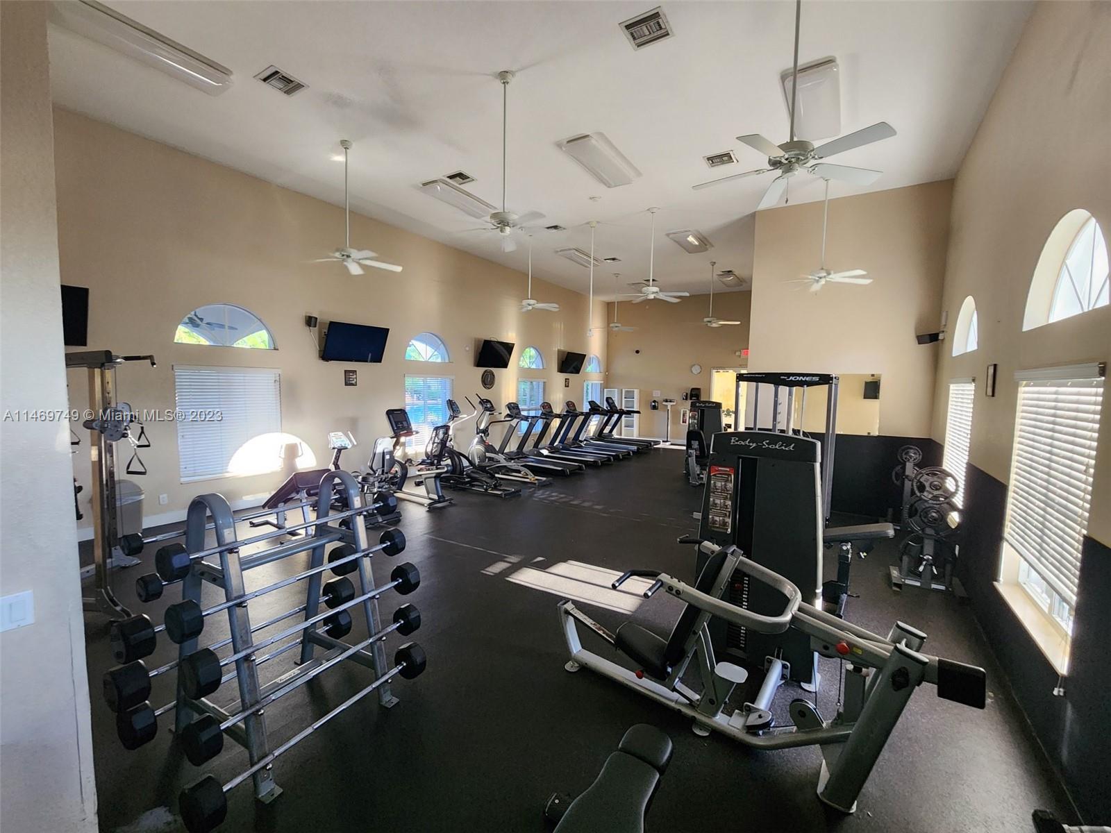 13986 Southwest 276th Street Homestead, FL 33032 - Photo 24 of 28 a room with gym equipment and a view of living room