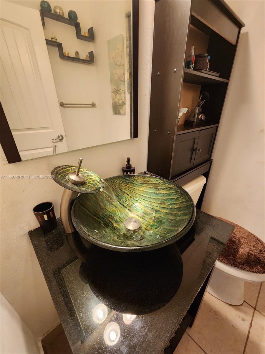 13986 Southwest 276th Street Homestead, FL 33032 - Photo 3 of 28 a bathroom with a sink and mirror