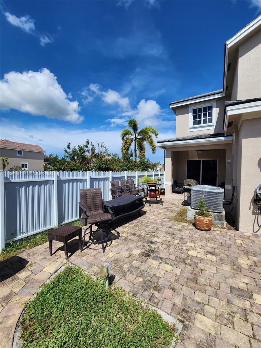 13986 Southwest 276th Street Homestead, FL 33032 - Photo 4 of 28 a view of a roof deck with table and chairs a barbeque