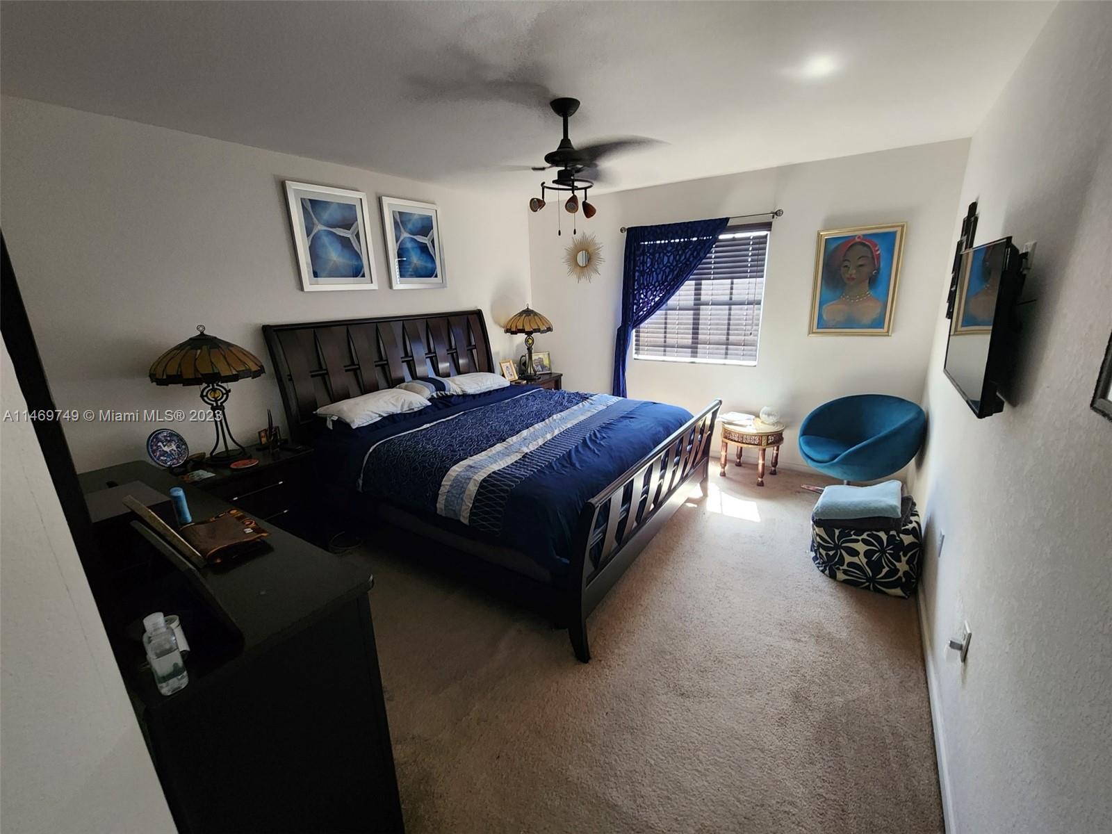 13986 Southwest 276th Street Homestead, FL 33032 - Photo 7 of 28 a spacious bedroom with a bed and a chandelier
