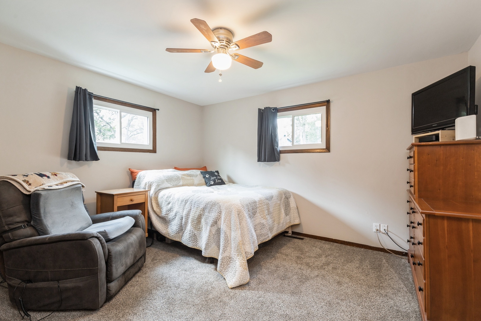 7701 Cedar Road Wonder Lake, IL 60097 - Photo 11 of 23 a bedroom with a bed and a flat screen tv