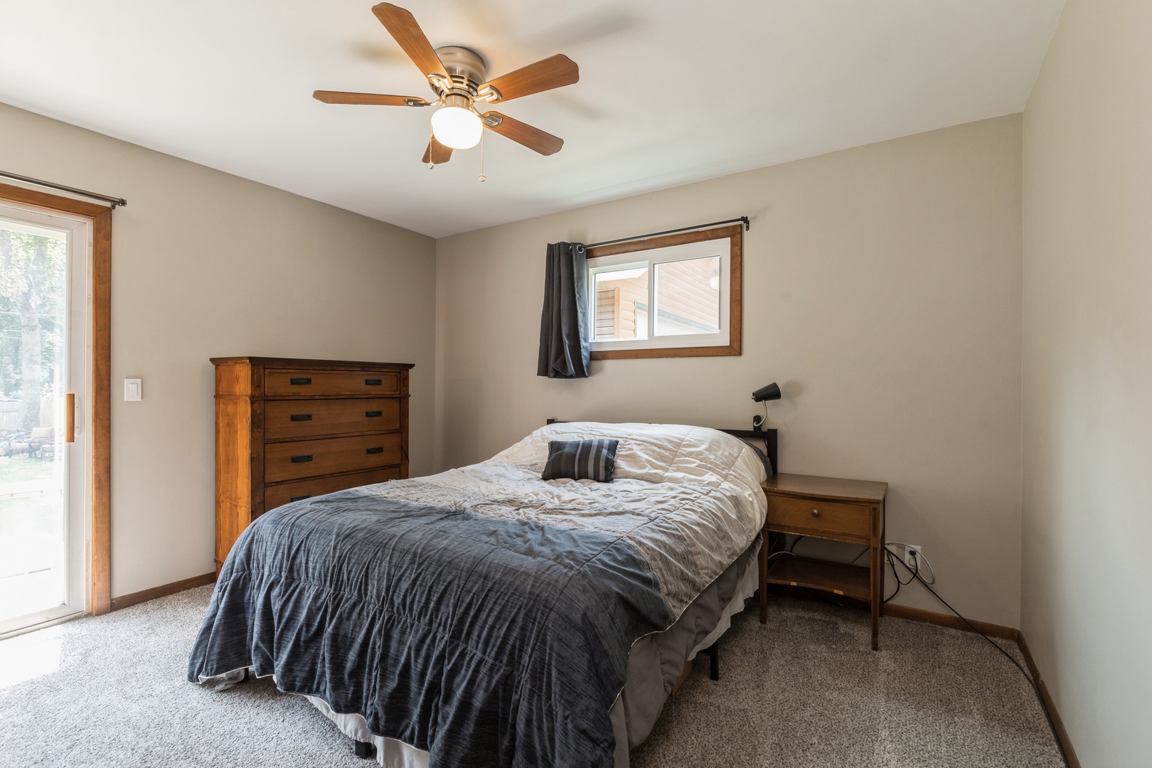 7701 Cedar Road Wonder Lake, IL 60097 - Photo 13 of 23 a bedroom with a bed and a chandelier