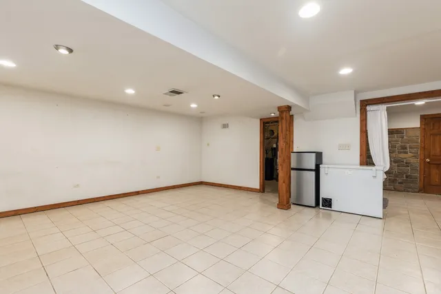 an empty room with fireplace and windows