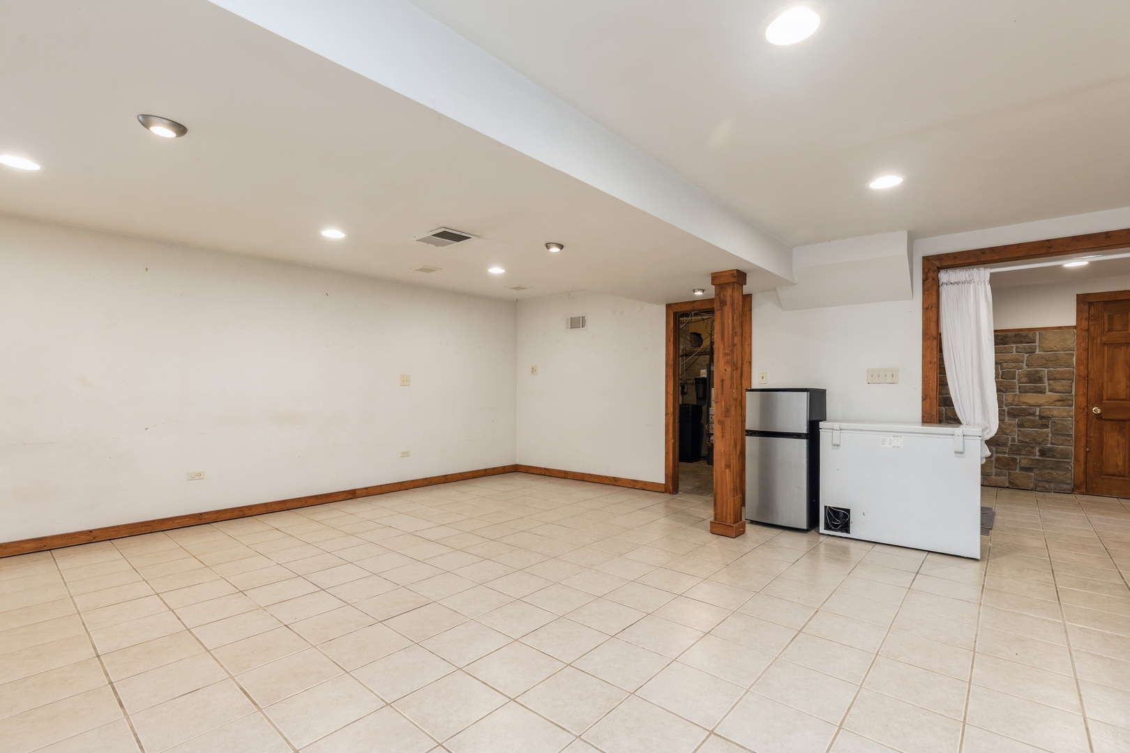7701 Cedar Road Wonder Lake, IL 60097 - Photo 17 of 23 an empty room with fireplace and windows