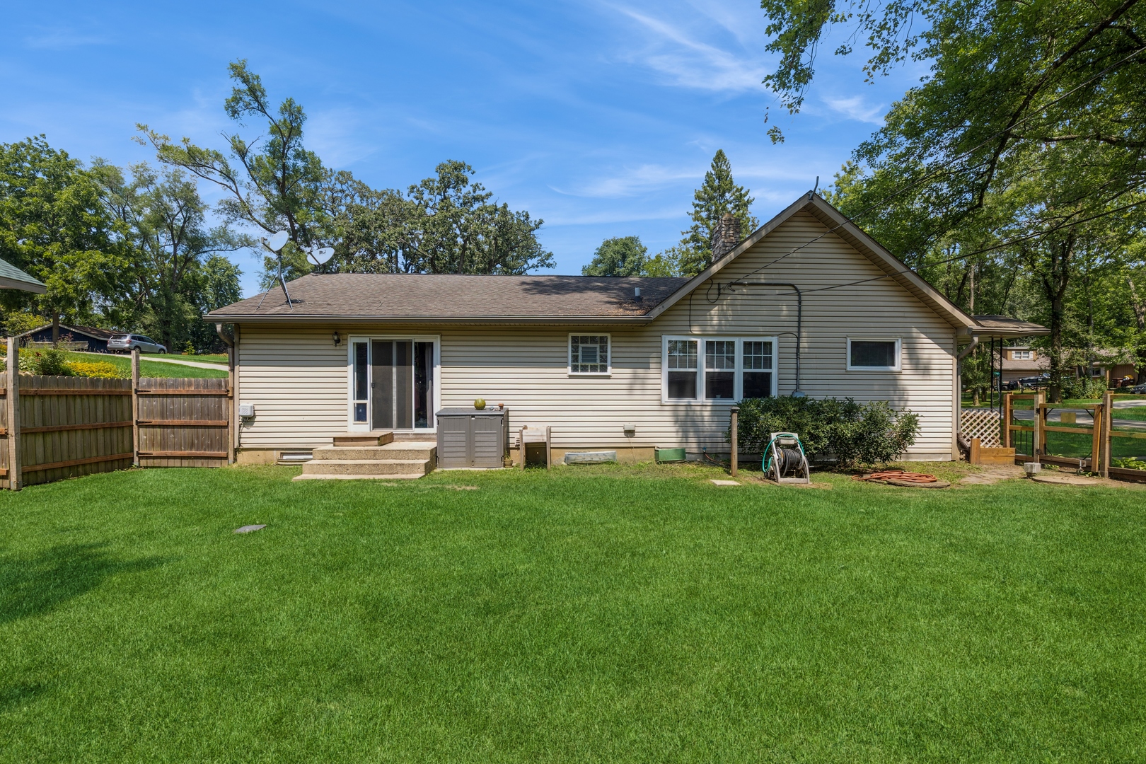 7701 Cedar Road Wonder Lake, IL 60097 - Photo 18 of 23 a front view of house with yard and outdoor seating