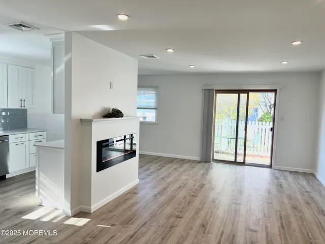 a kitchen with a wooden floor and white appliances