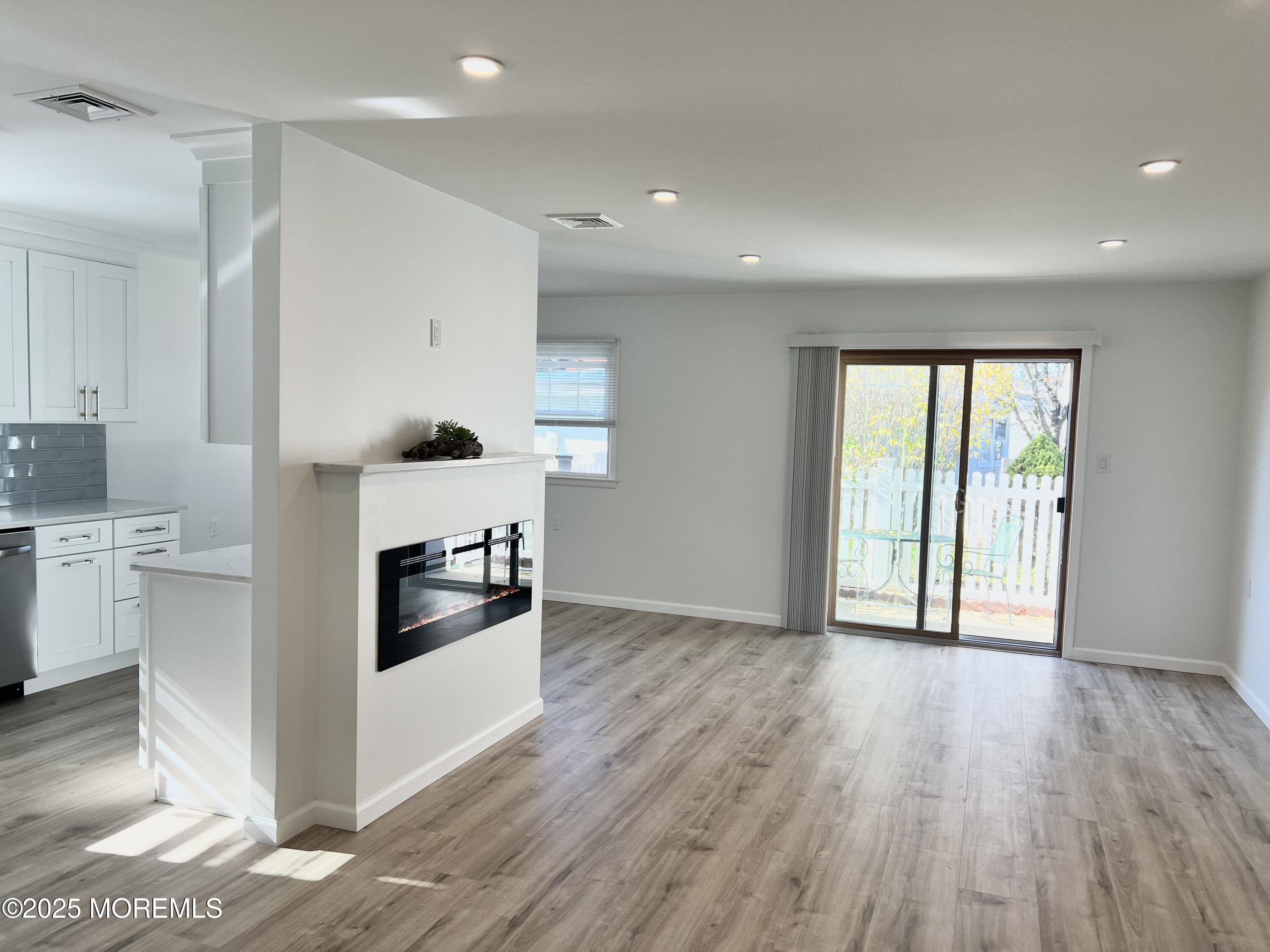 20 Lamb Road Brick, NJ 08724 - Photo 7 of 31 a kitchen with a wooden floor and white appliances