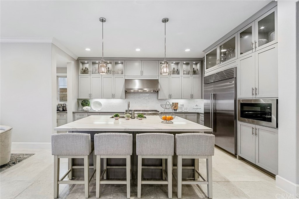 65 Rockinghorse Irvine, CA 92602 - Photo 13 of 51 a kitchen with stainless steel appliances kitchen island granite countertop a kitchen island and chairs in it