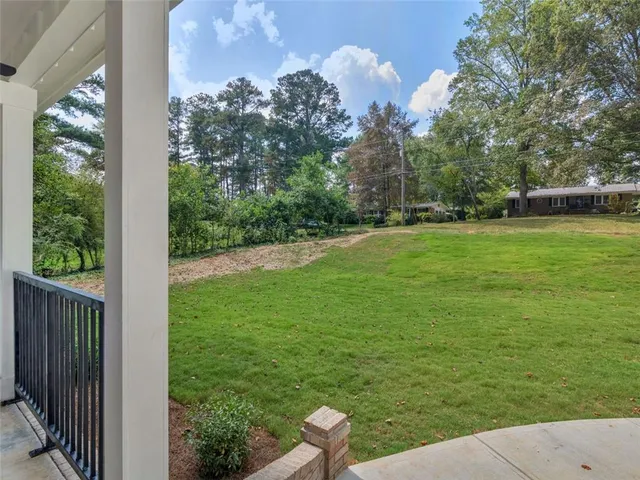a view of a backyard with large trees