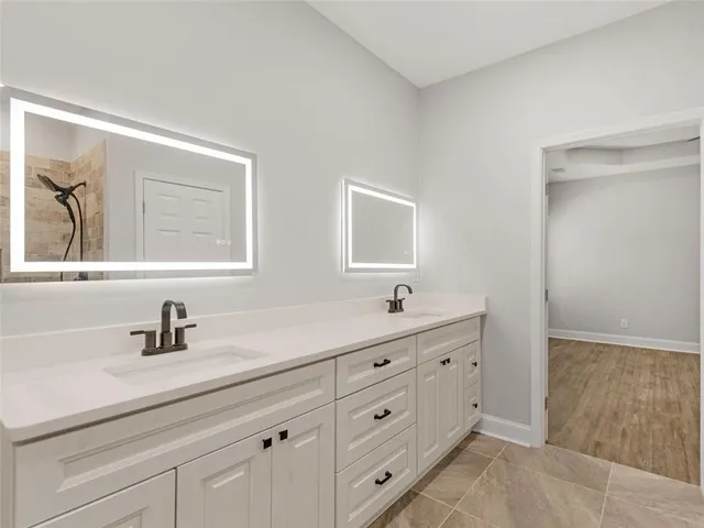 a bathroom with a double vanity sink and mirror