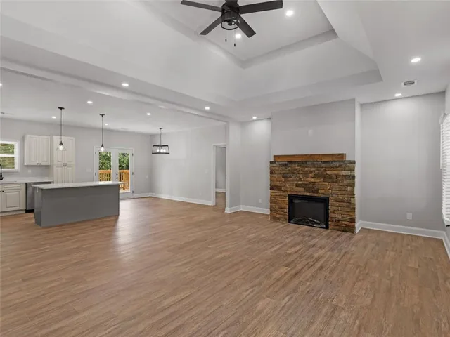 a view of an empty room with a fireplace and a window