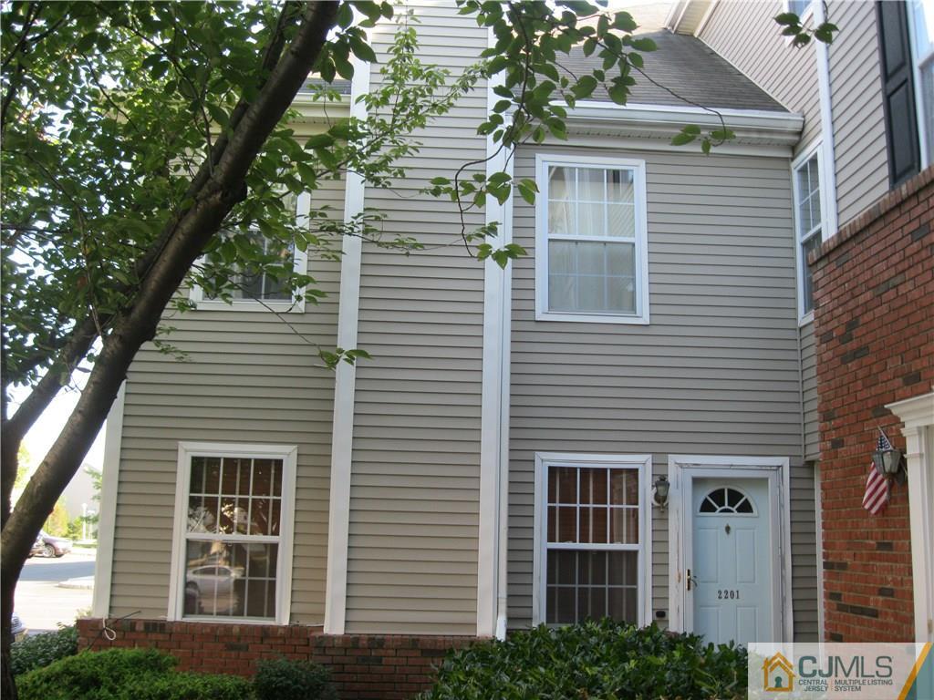 a front view of a house with a tree