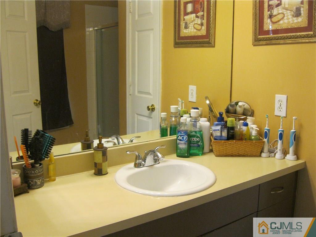 2201 Timber Ridge Court Sayreville, NJ 08859 - Photo 12 of 17 a bathroom with a double vanity sink and a mirror