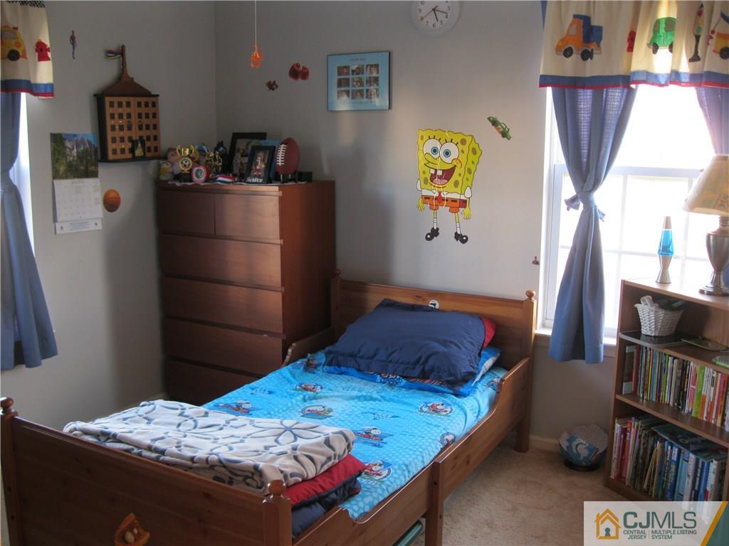 2201 Timber Ridge Court Sayreville, NJ 08859 - Photo 14 of 17 a bedroom with a bed and wooden floor