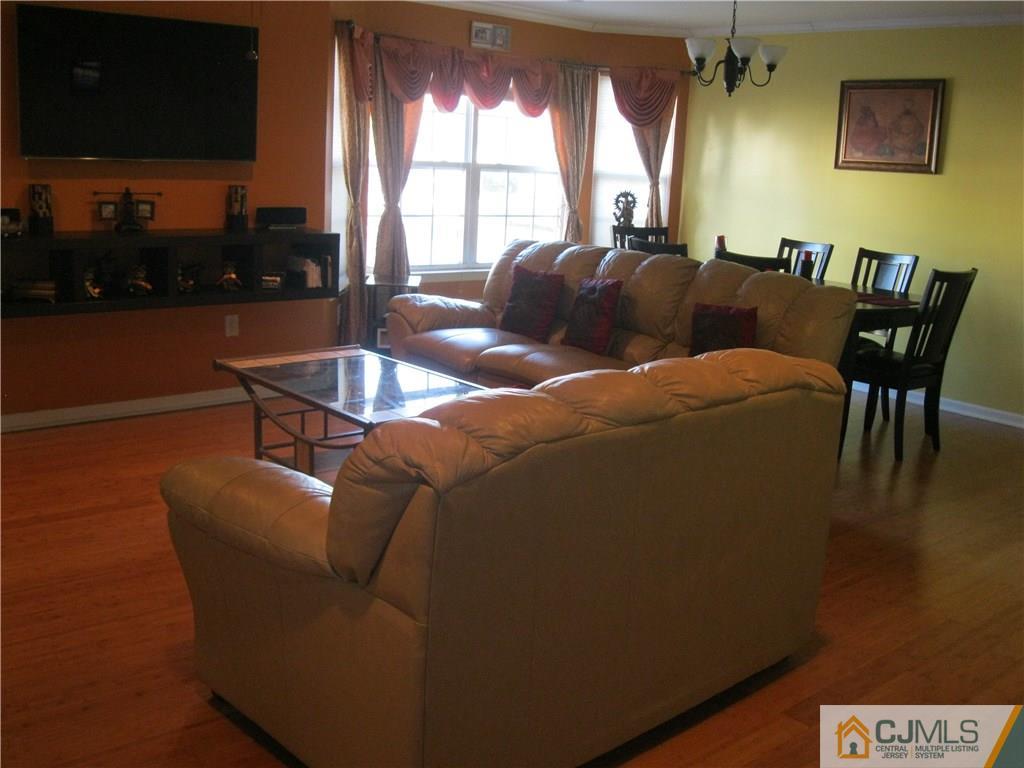 2201 Timber Ridge Court Sayreville, NJ 08859 - Photo 4 of 17 a living room with furniture and a floor to ceiling window