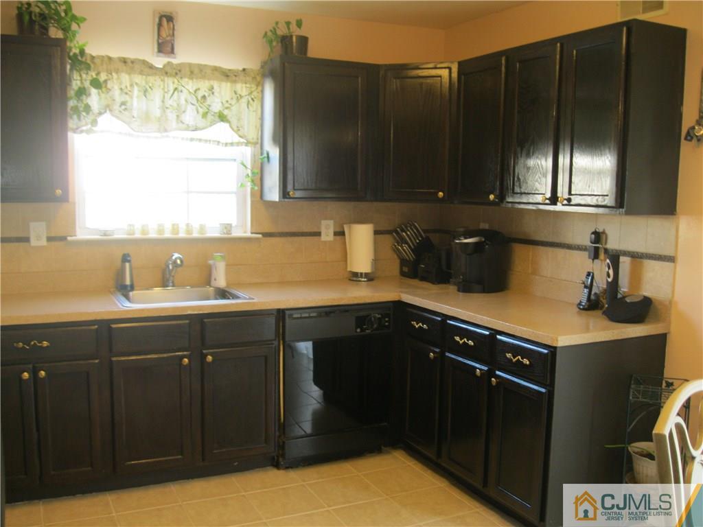 2201 Timber Ridge Court Sayreville, NJ 08859 - Photo 9 of 17 a kitchen with a sink cabinets and window