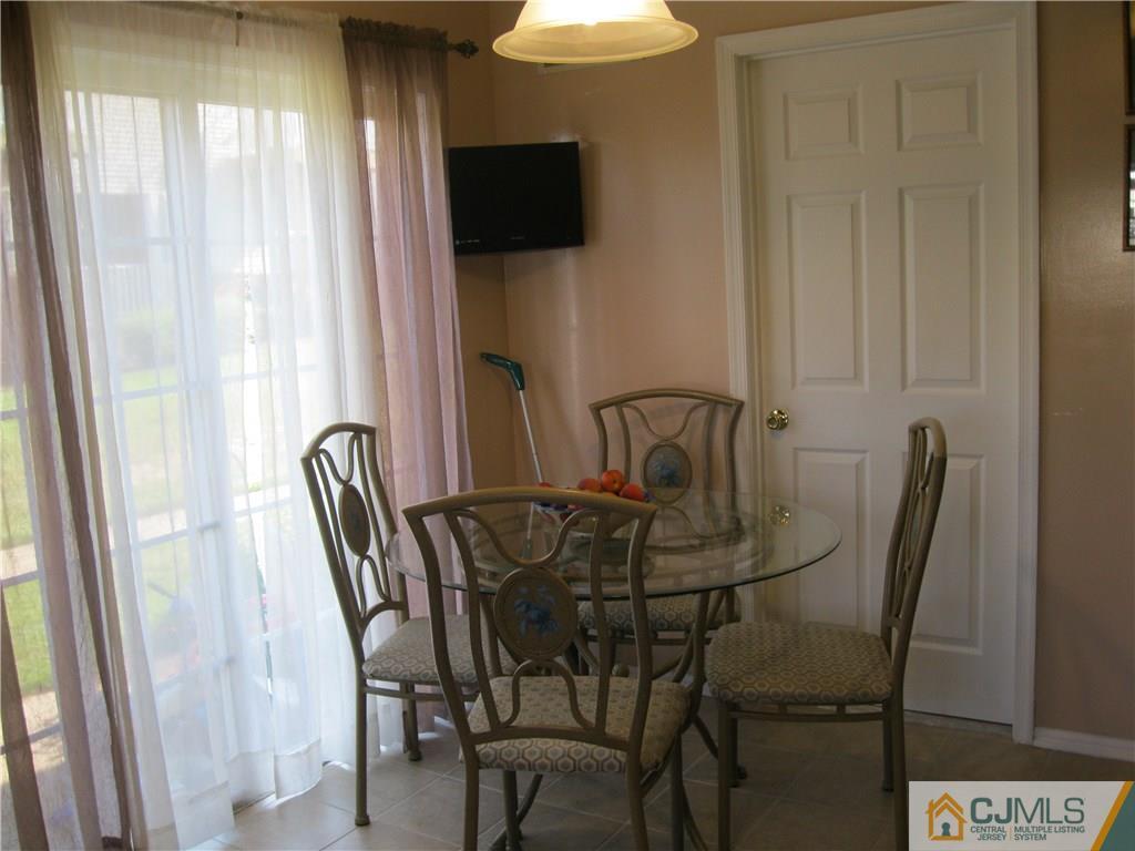 2201 Timber Ridge Court Sayreville, NJ 08859 - Photo 10 of 17 a view of a dining room with furniture and window