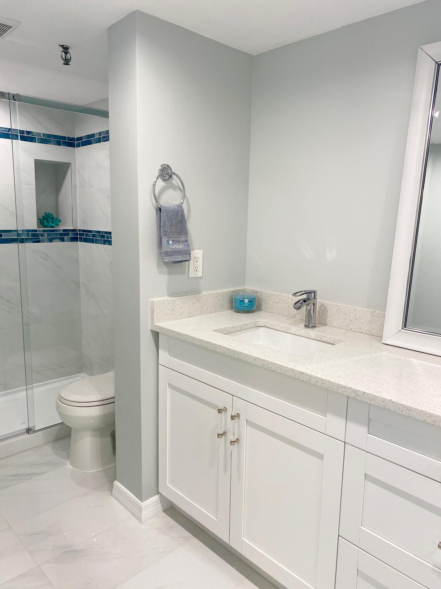 859 Jeffery Street, Unit 311 Boca Raton, FL 33487 - Photo 14 of 32 a bathroom with a sink a toilet and a mirror