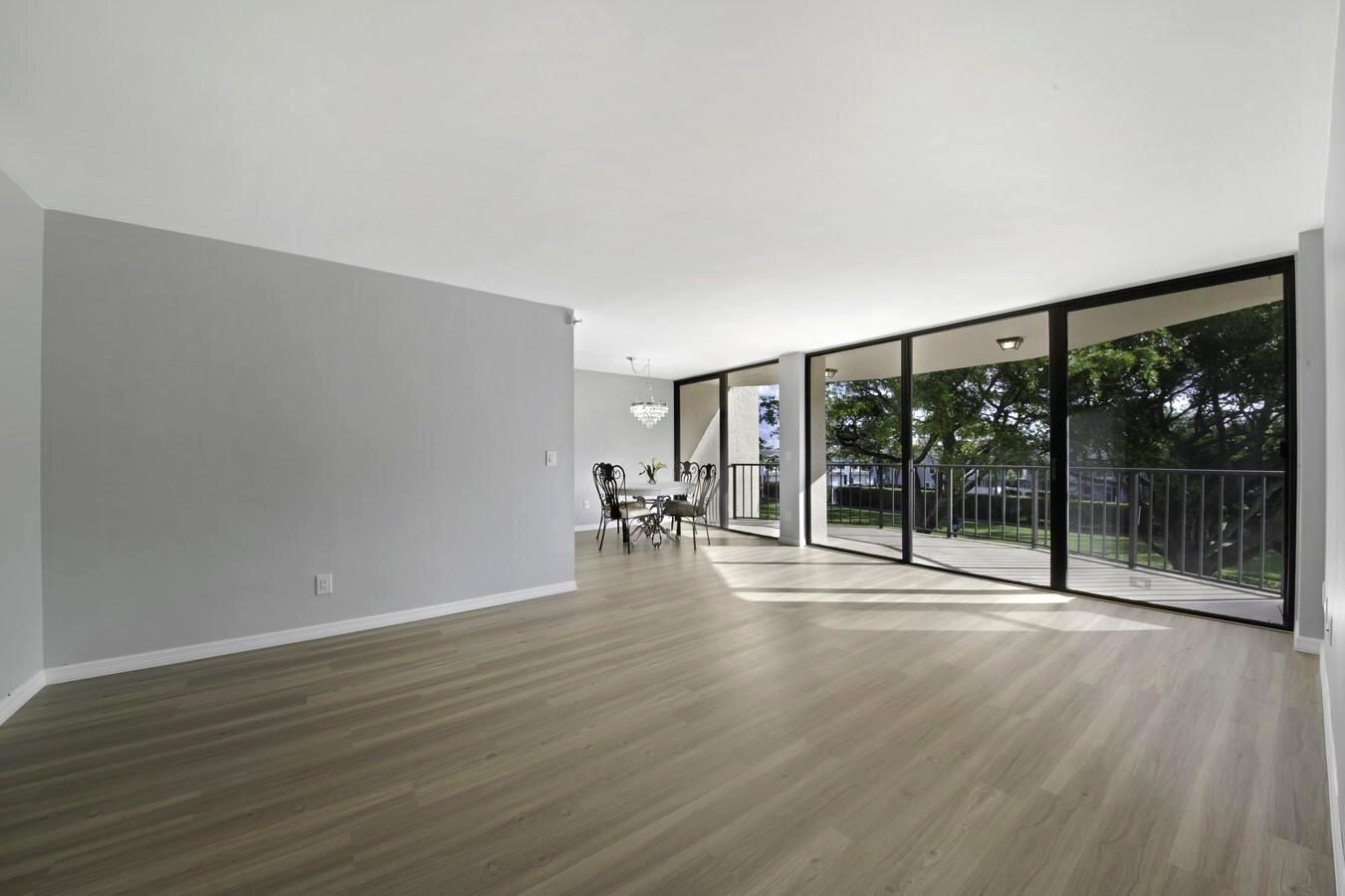 859 Jeffery Street, Unit 311 Boca Raton, FL 33487 - Photo 2 of 32 a big room with wooden floor and windows