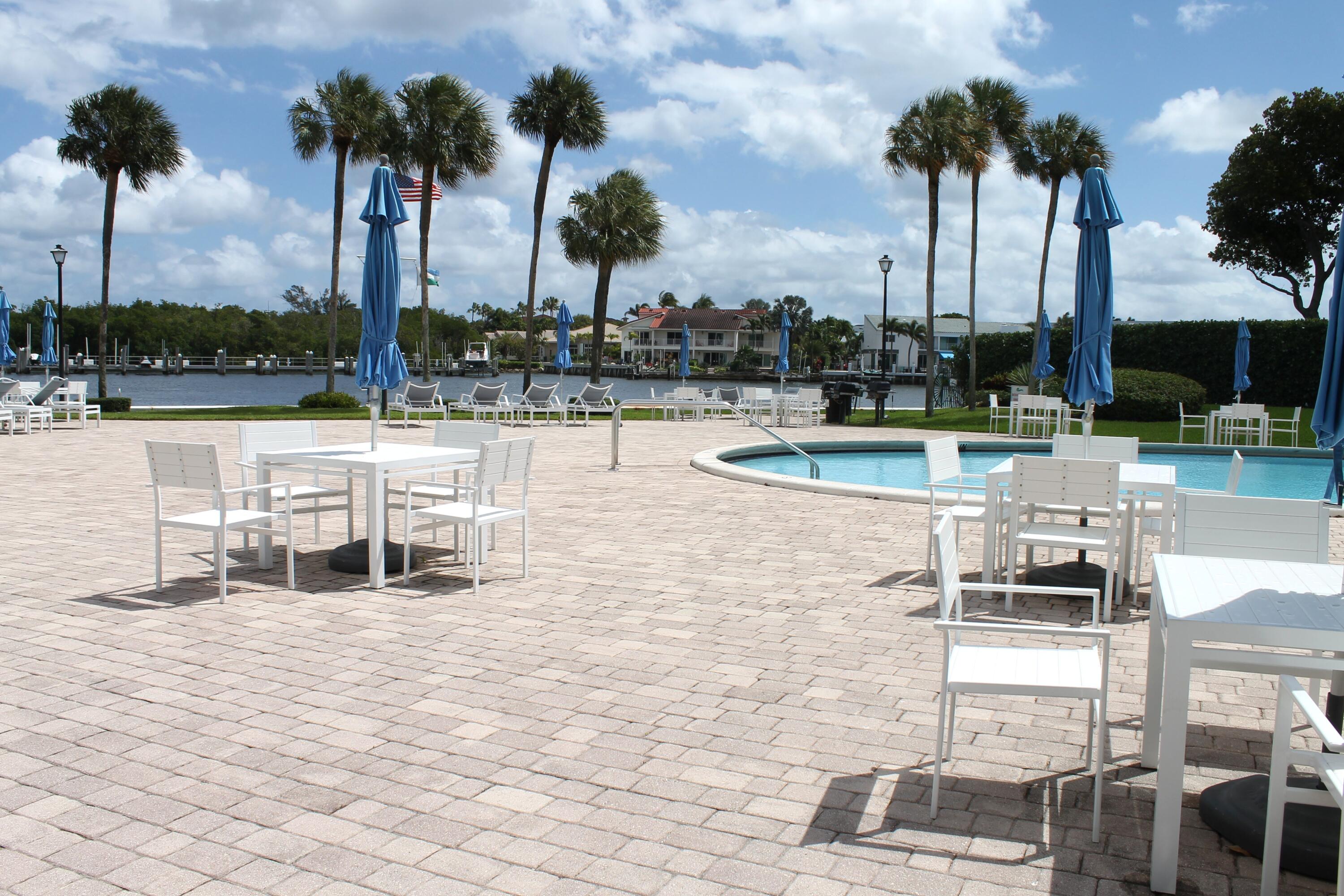 859 Jeffery Street, Unit 311 Boca Raton, FL 33487 - Photo 23 of 32 a view of a swimming pool with a chair