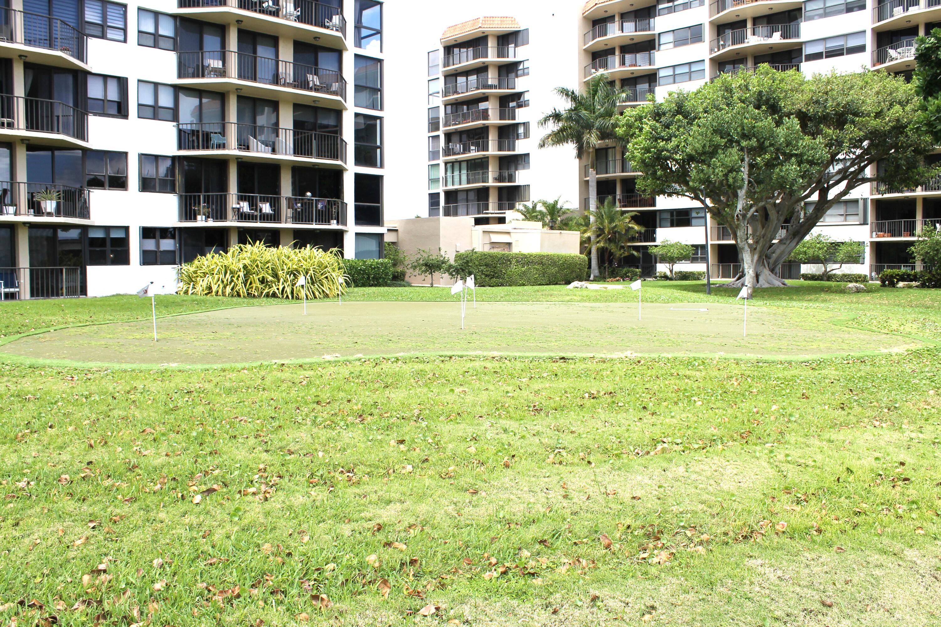 859 Jeffery Street, Unit 311 Boca Raton, FL 33487 - Photo 25 of 32 a front view of a building with a garden