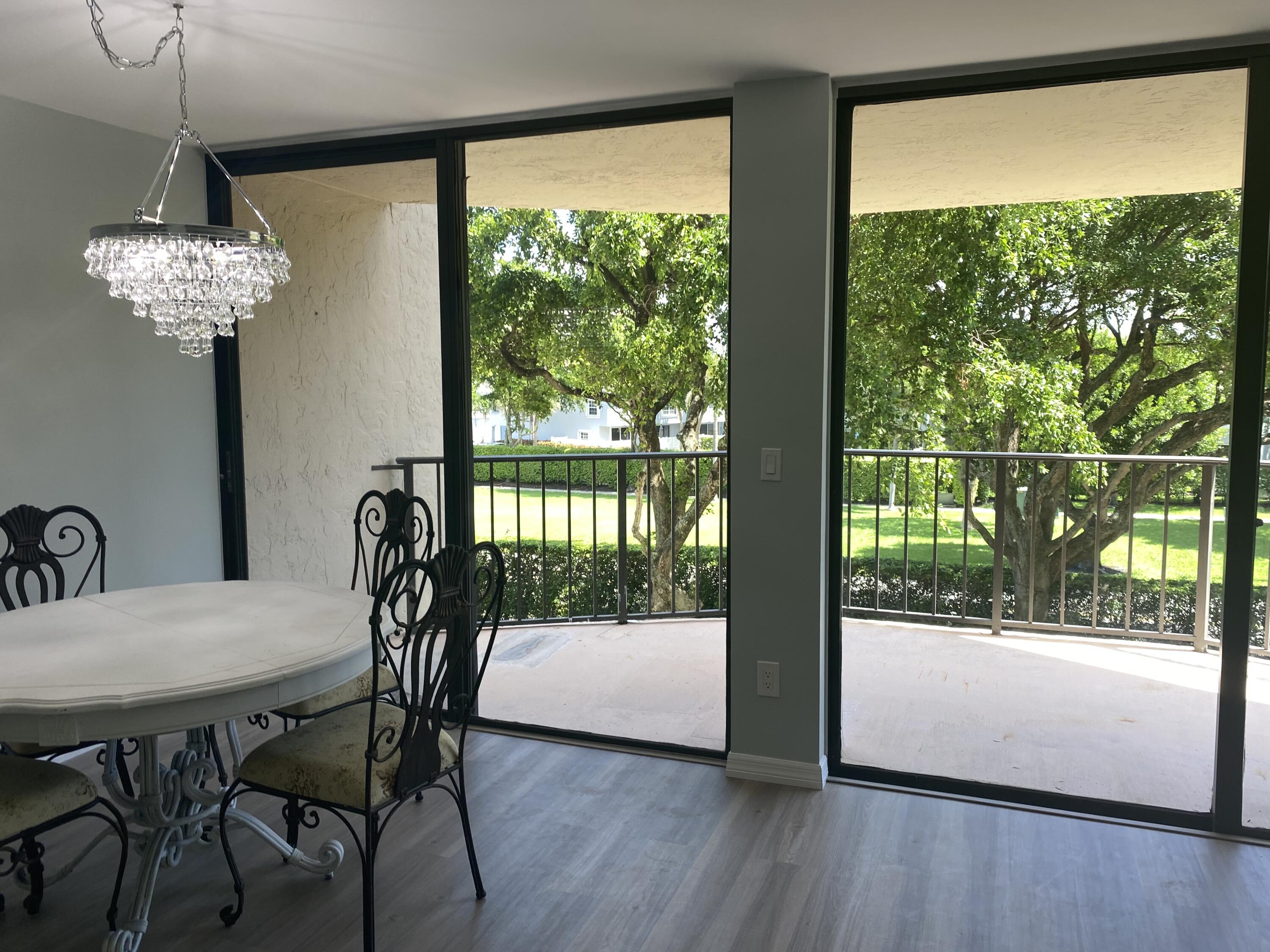 859 Jeffery Street, Unit 311 Boca Raton, FL 33487 - Photo 8 of 32 a view of a dining room with furniture window and wooden floor