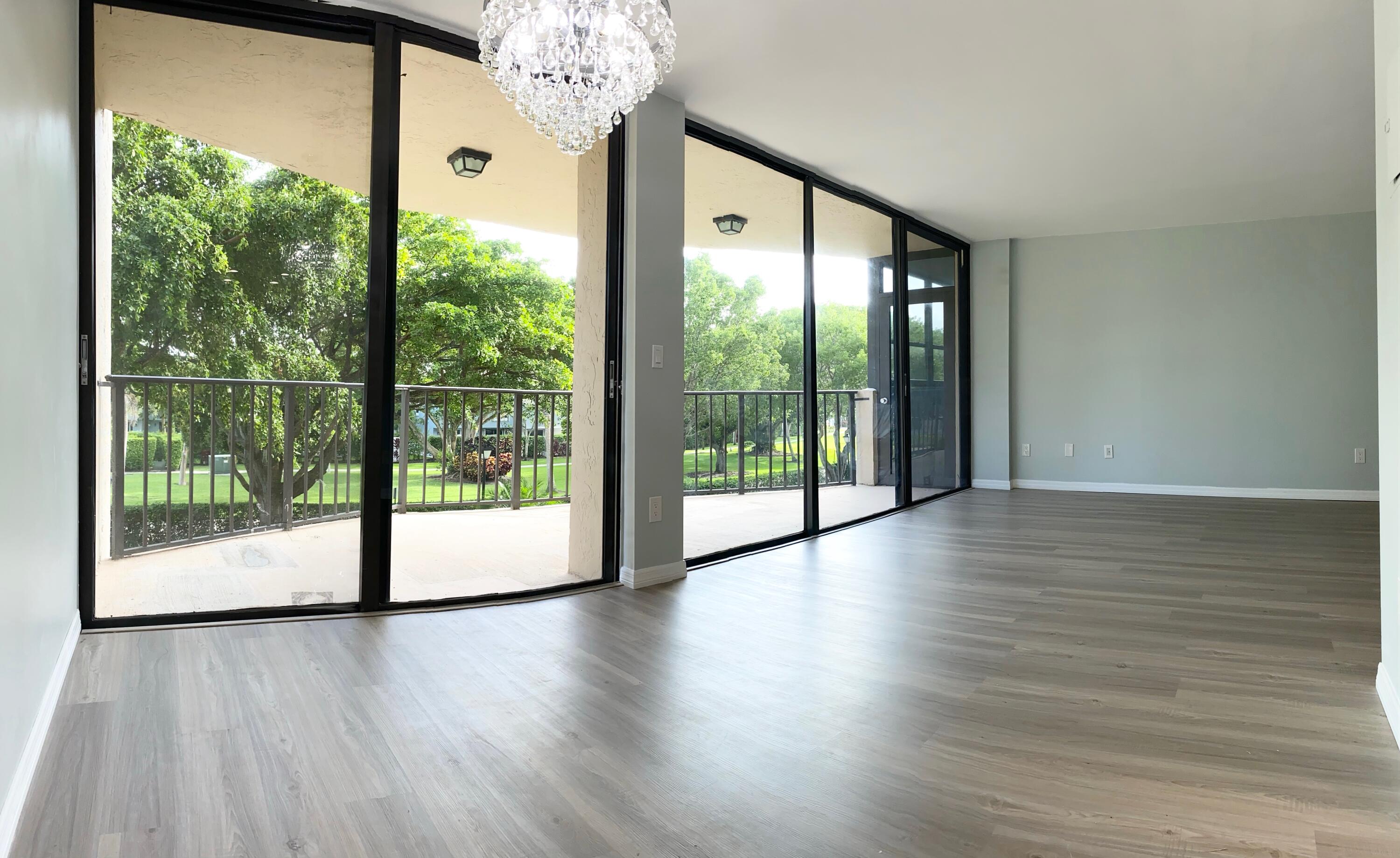 859 Jeffery Street, Unit 311 Boca Raton, FL 33487 - Photo 10 of 32 a view of an entryway with wooden floor and door