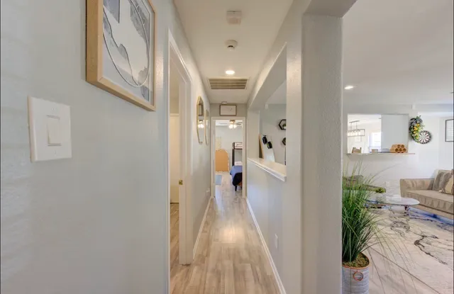 a view of a hallway view with wooden floor and staircase