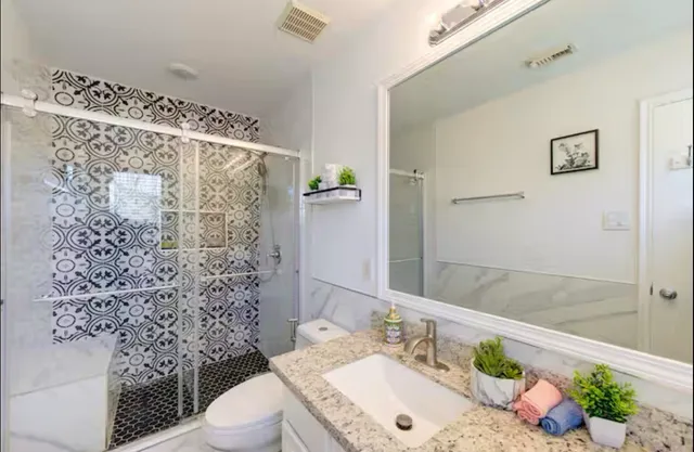 a bathroom with a sink toilet and shower