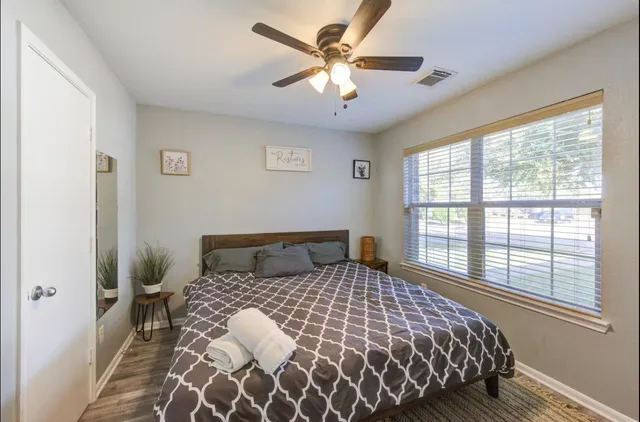 a bedroom with a bed and a couch