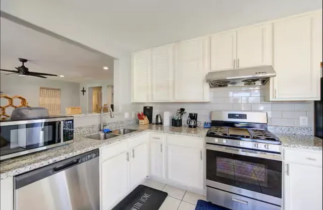 a kitchen with a stove and a refrigerator