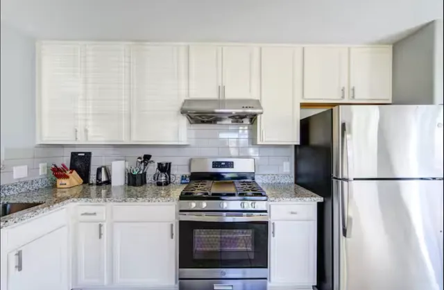 a view of a house with backyard and a garden