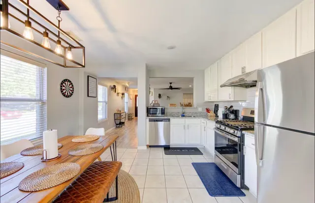 a kitchen with a refrigerator and a stove