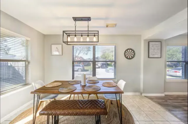 a view of a dining room with furniture a chandelier and wooden floor