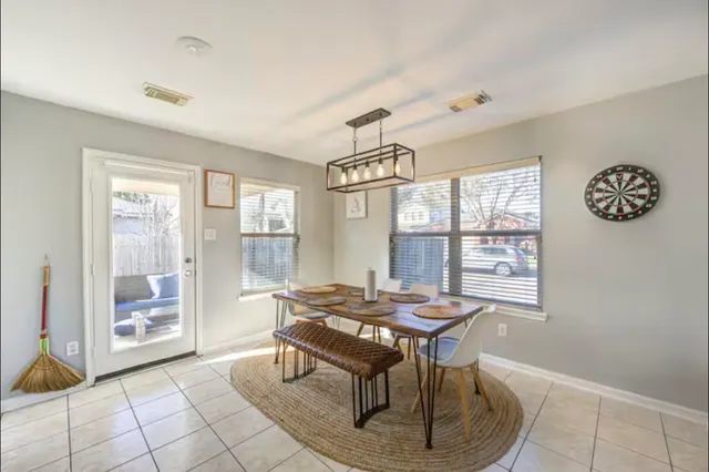 a dining room with furniture and window