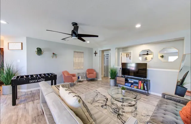 a bedroom with furniture and a flat screen tv