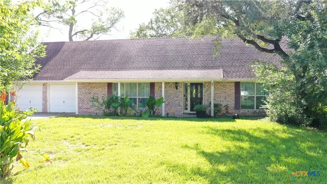 a view of a house with a yard and sitting area