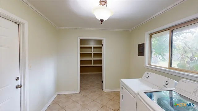 a utility room with cabinets washer and dryer