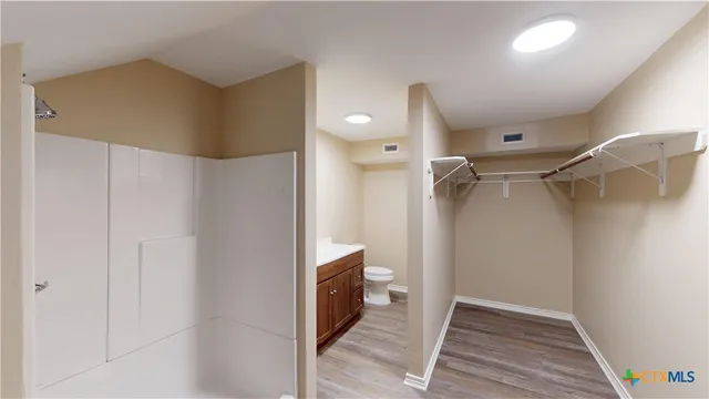 a bathroom with a shower and a glass door
