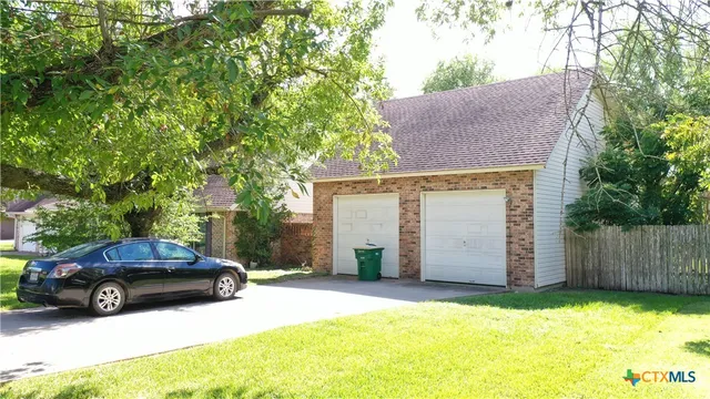 a view of a car parked in front of house