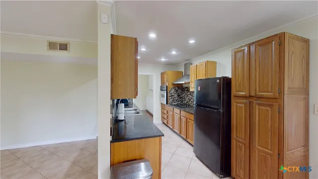 a kitchen with a refrigerator and a stove