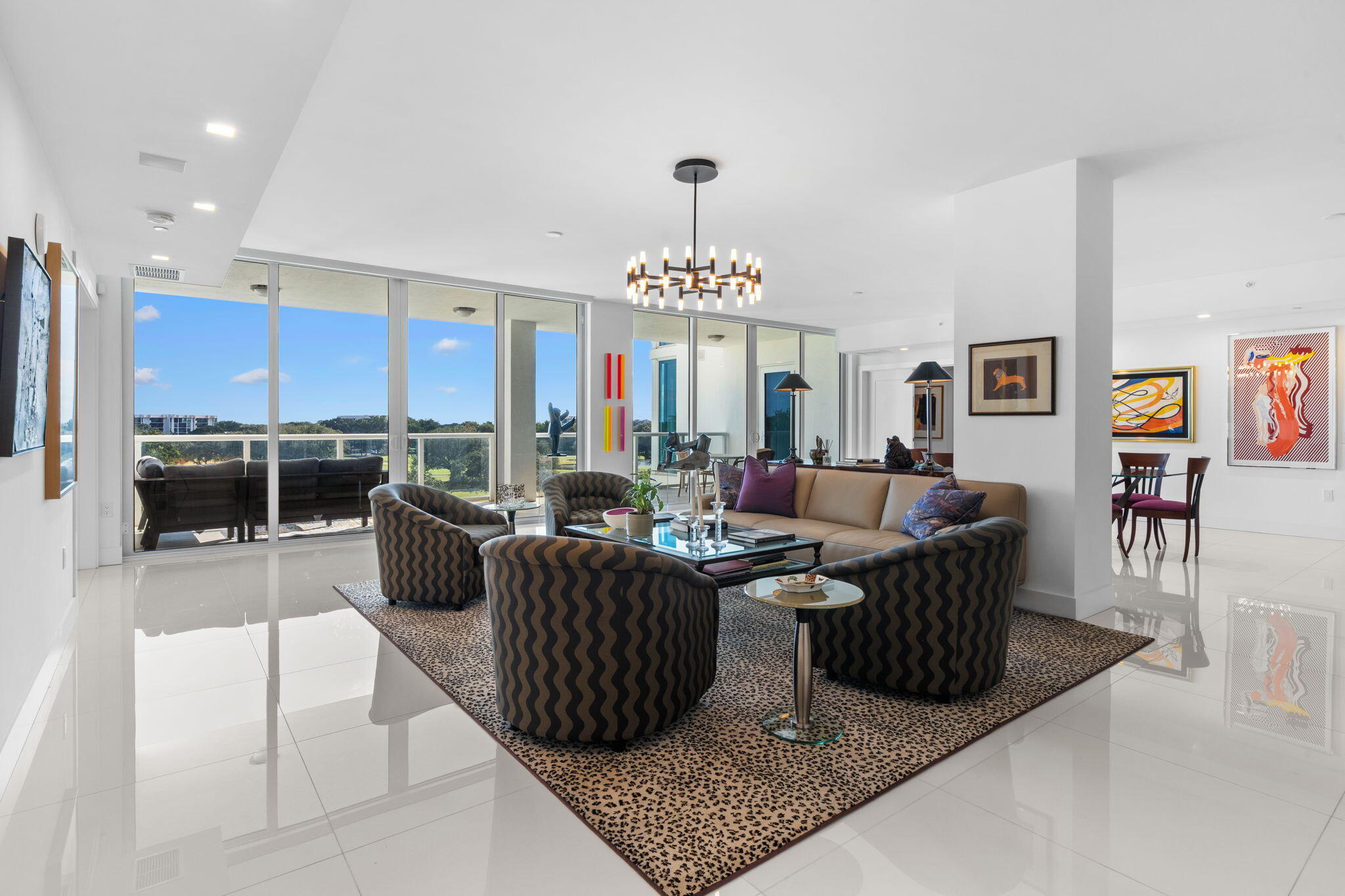 20155 Boca W Drive, Unit A404 Boca Raton, FL 33434 - Photo 2 of 52 a living room with lots of furniture and a chandelier