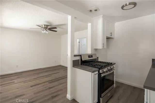 a kitchen with granite countertop a stove and a sink with granite countertops