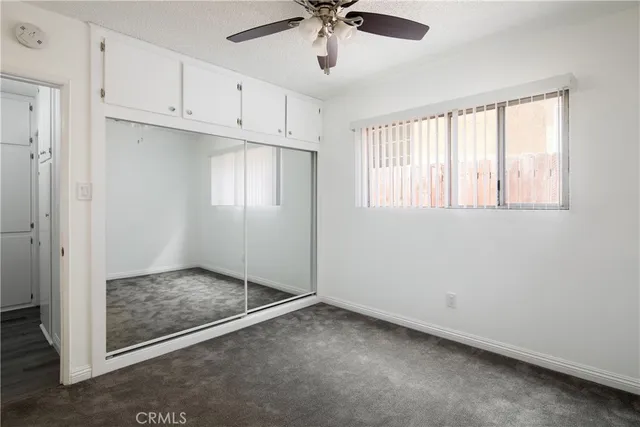a view of a livingroom with a ceiling fan and window
